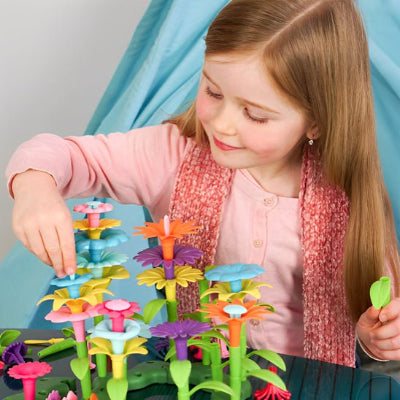 jeux de construction créakid fillette construisant un jardin de fleurs